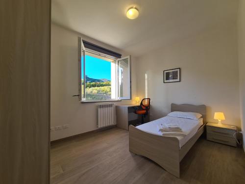 a bedroom with a bed and a large window at Santa Caterina in Levanto