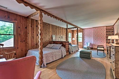 a bedroom with a bed in a room with wooden walls at Amazing Historic Home with Stunning Mountain Views! in Blowing Rock