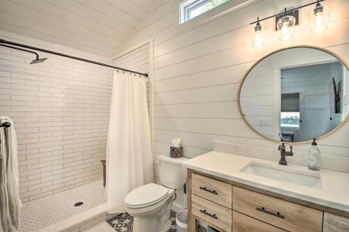 a bathroom with a toilet and a sink and a mirror at Blue Ridge Cottage Modern Solace in the Mountains in Blue Ridge