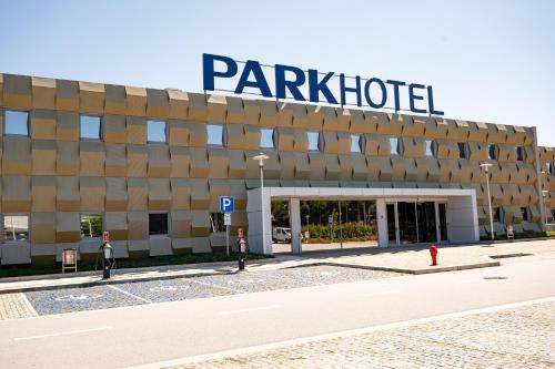 
a large building with a sign on the side of it at Park Hotel Porto Aeroporto in Maia
