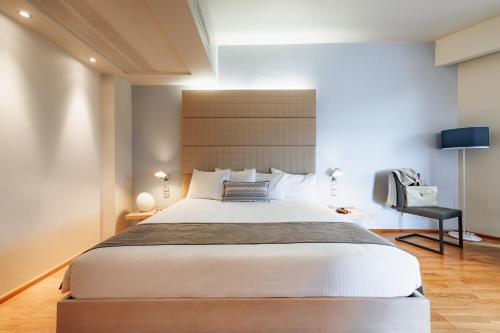 a bedroom with a large bed and a desk at Domotel Olympia in Thessaloniki