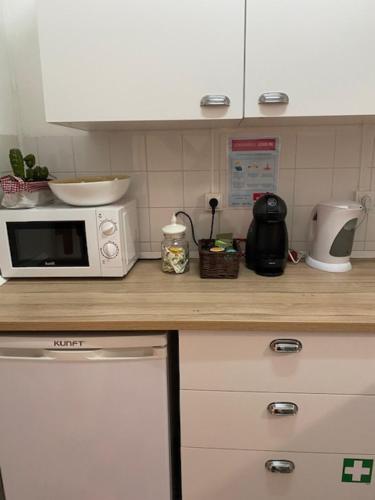 a kitchen with a counter with a microwave on it at Mouraria 1 - Descubra a Lisboa Medieval in Lisbon