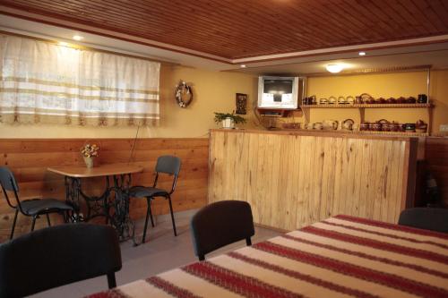 a room with a table and chairs and a kitchen at Dream House in Yaremche