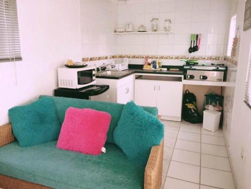 sala de estar con sofá verde en la cocina en Trailer Beach Front Cottage, en Savaneta