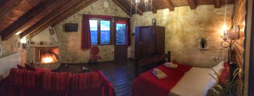 a bedroom with a bed and a fireplace in a room at Anilia Guesthouse in Synikia Mesi Trikalon