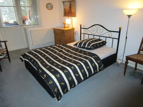 a bedroom with a bed with a black and white comforter at ABT Private Rooms - Bed and Breakfast - Hannover (room agency) in Hannover
