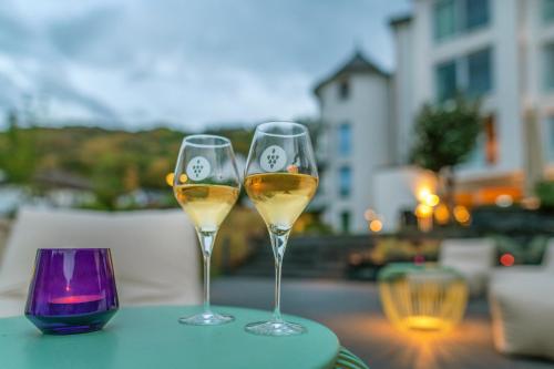 two glasses of white wine sitting on a table at Moselromantik Hotel Kessler Meyer in Cochem