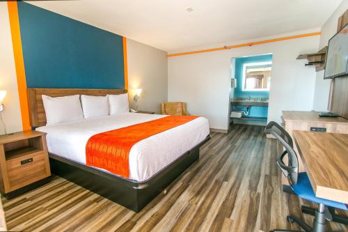 a hotel room with a bed and a desk at Jubilee Inn in Biloxi