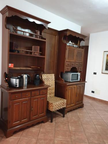 a kitchen with wooden cabinets and a microwave at B&B collina e mare in Camogli