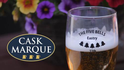 a glass of beer with a label on it at The Five Bells, Eastry in Sandwich