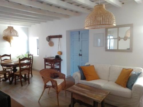 a living room with a white couch and a table at La Puerta Azul in Bornos