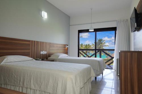 En eller flere senge i et værelse på Aram Imirá Beach Resort
