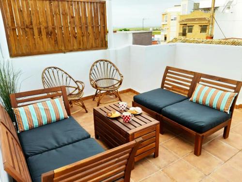 a patio with two chairs and a table at Hostal El Perelló, Valencia in El Perelló