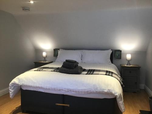 a bedroom with a bed with a pile of clothes on it at Number One in Haddington