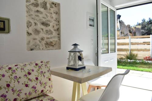 a living room with a table and a chair at Marinakis Sea View Studios in Sougia