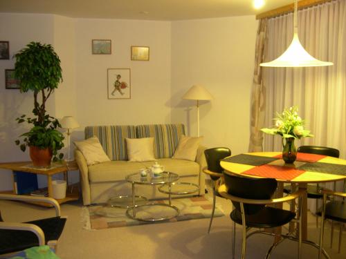 a living room with a couch and a table at Panorama A23 Fitzi - Ferienwohnung für 1-2 Personen in Flims