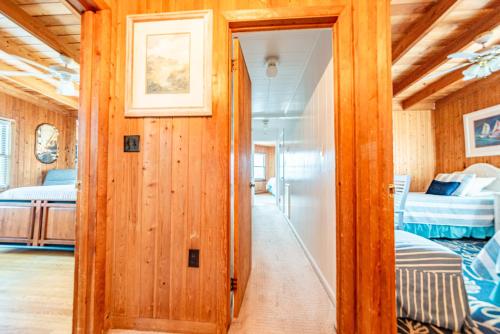 a hallway leading to a bedroom with two beds at Gypsea Rose in Southern Shores