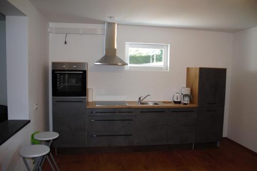 a kitchen with a sink and a microwave at Apartments Traun-haft in Bad Aussee