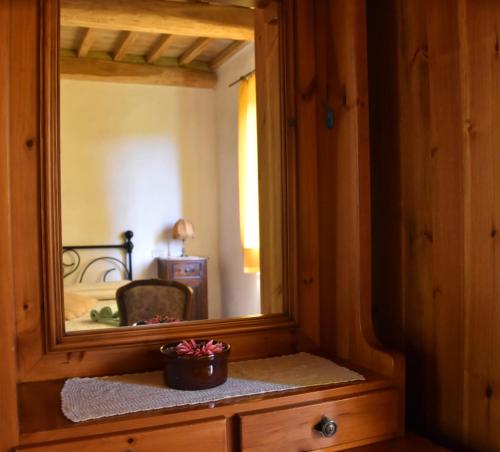 a mirror sitting on top of a dresser in a room at Casa Vacanze Porta Vecchia in Montalcino