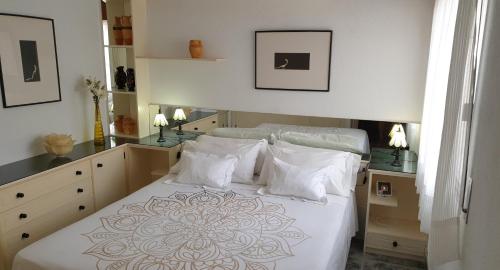 a bedroom with a large bed with white sheets and pillows at Cristimar - stunning Vacation Rental Home for families & friends in Los Cristianos