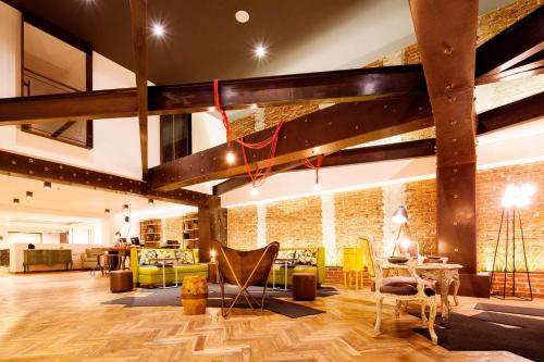 a living room with wooden floors and a brick wall at Hotel Presidente in San José