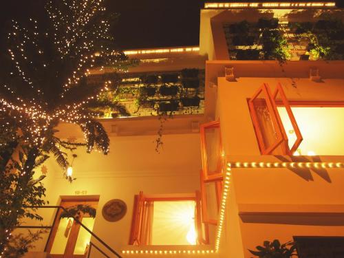 a building with christmas lights on the side of it at Leclerc Hotel Boutique Cali Granada in Cali