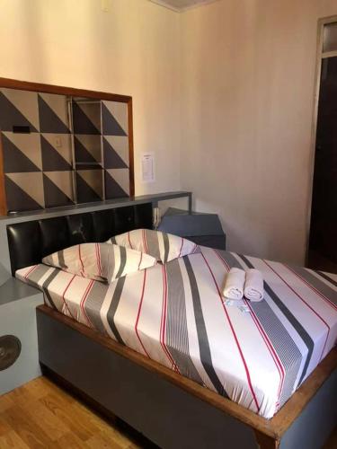 a bed with two pillows on it in a room at Hotel Popular Vila Mariana in São Paulo