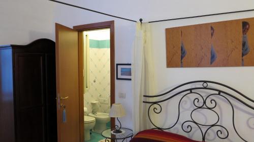 a bedroom with a bed and a bathroom with a toilet at - B&B "Centro Antico" - in Naples