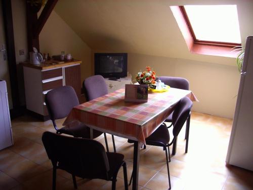 a dining room with a table and some chairs at Pohodový apartmán s terasou in Úpice