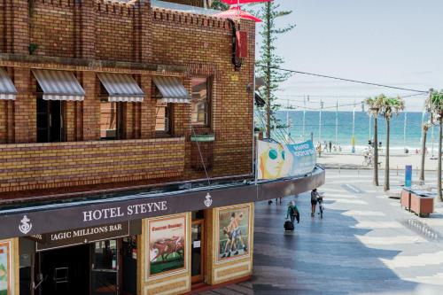 a building on a street next to the beach at Stay at Hotel Steyne in Sydney
