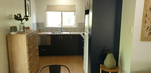 a small kitchen with a sink and a window at Donnybrook Cottages - Hutt River in Clare