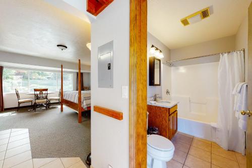 a bathroom with a toilet and a sink in a room at Deschutes Riverside Escape in Bend