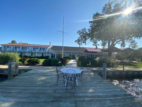 a table and chairs sitting on a wooden deck at Tilghman Island Inn in Tilghman Island