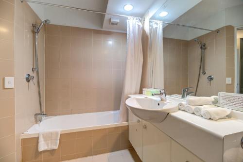 a bathroom with a sink and a bath tub at Lakefront Apartments,18 LAKE ESPLANADE ROAD in Queenstown