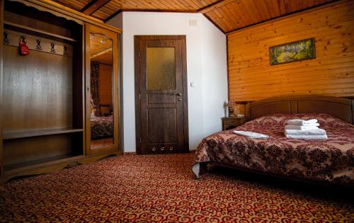 a bedroom with a bed with towels on it at Karpatska Vezha in Migovo