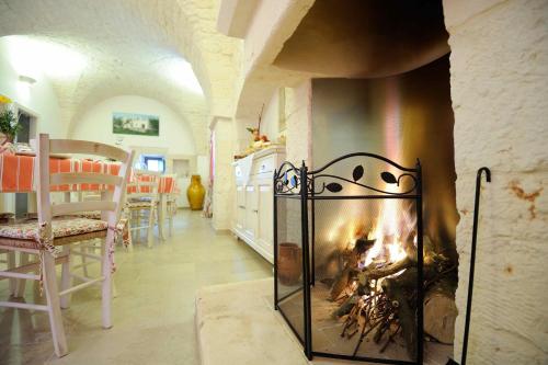 a fireplace in a living room with a fire at Agriturismo Arco di Sole in Alberobello
