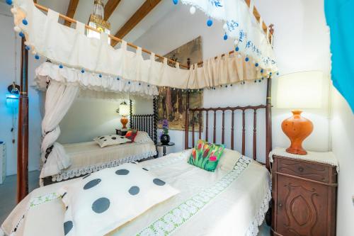 a bedroom with two beds and a canopy bed at Bon Son Fiol in Felanitx