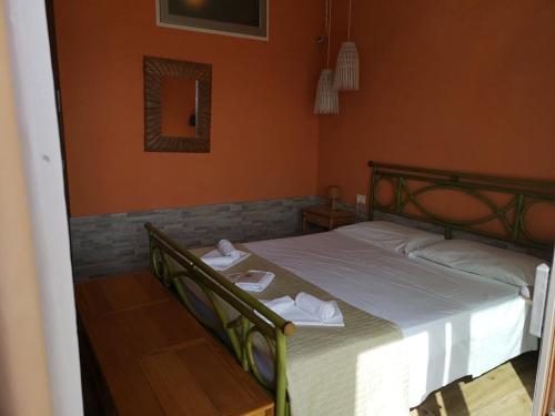 a bedroom with a bed with two towels on it at La Rosa dei Venti Resort in Piombino