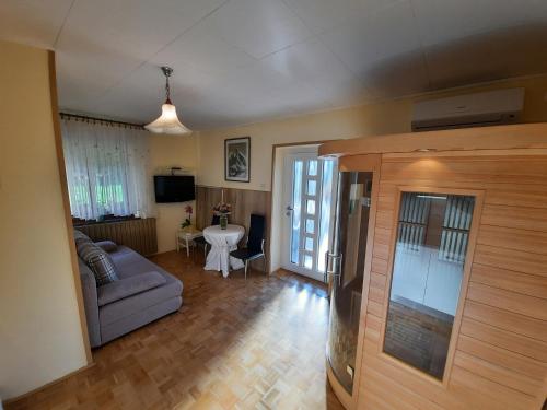 a living room with a couch and a table at Chalet and Apartment Žonir with SAUNA in Kobarid