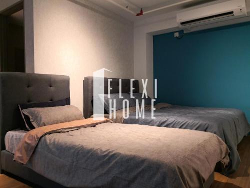 a bedroom with two beds and a sign that says ieek home at Pinnacle PJ, Romantic City View, 1-4 Guests Designed Duplex Home by Flexihome-MY in Petaling Jaya