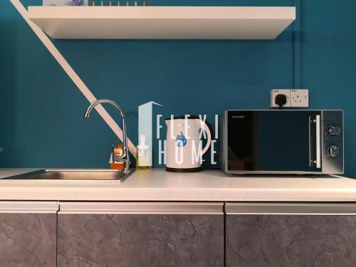 a kitchen counter with a sink and a microwave at Pinnacle PJ, Romantic City View, 1-4 Guests Designed Duplex Home by Flexihome-MY in Petaling Jaya
