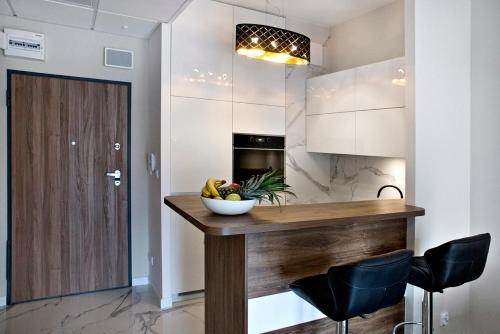 Prymasa Tysiaclecia - P&O Serviced Apartments tesisinde mutfak veya mini mutfak