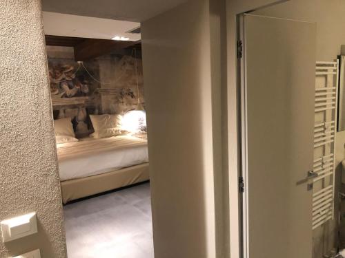 a bedroom with a bed and a mirror at Villa Cantoni Marca in Sabbioneta