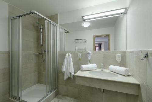 a bathroom with a sink and a shower at Hotel Hvezda in Pec pod Sněžkou