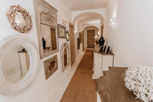 a hallway with a large mirror on the wall at Relais Villa Carola in Porto Cervo