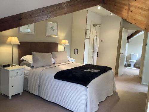 a bedroom with a large bed and a bathroom at Alexandra Court in Harrogate