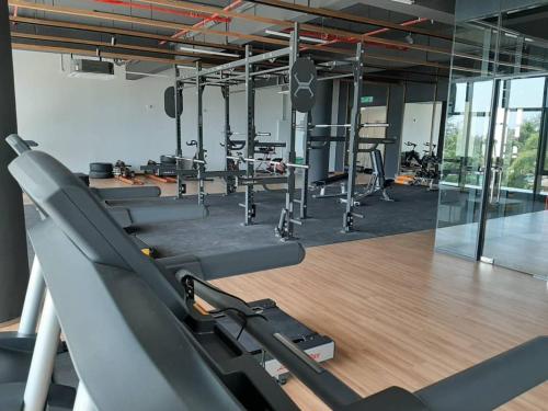 a gym with rows of treadmills and exercise bikes at Timurbay Treasures Studio Apartment Side Seaview with Wifi Neflix in Kuantan