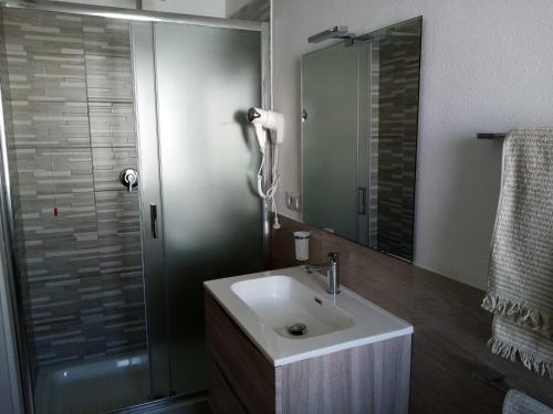 a bathroom with a sink and a shower at Affittacamere Alisso in Olbia