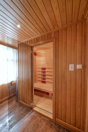 a wooden room with a sauna with a glass door at Villa Fiikova in Medven