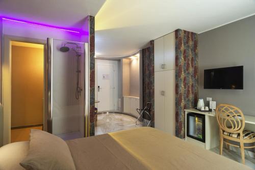 a bedroom with a bed with a purple light at Etruria Relais and Wine in Rome